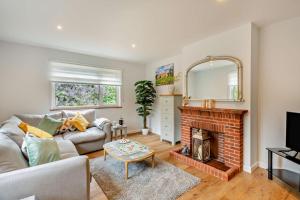 a living room with a couch and a fireplace at 3 Bed in Acton oc-c28929 in Waldingfield