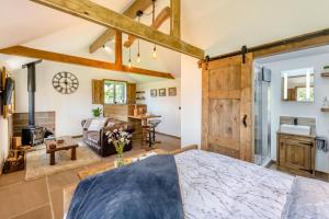 a bedroom with a large bed and a living room at 1 Bed in Okehampton oc-p29017 in Okehampton