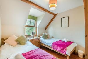 a bedroom with two beds and a window at 3 Bed in Manorbier oc-pw270a in Manorbier