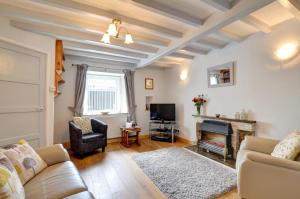a living room with a couch and a fireplace at 3 Bed in Pwllheli oc-wag486 in Bryncroes