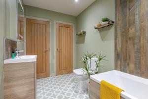 a bathroom with a tub and a toilet and a sink at 1 Bed in Wycliffe oc-t29946 in Wycliffe +20 photos