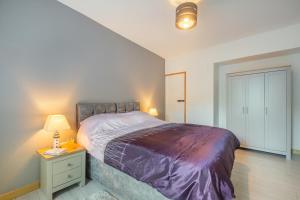 a bedroom with a bed and a table with a lamp at 1 Bed in Nefyn oc-n28983 in Nefyn