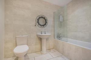 a bathroom with a toilet and a sink and a shower at 1 Bed in Nefyn oc-n28983 in Nefyn