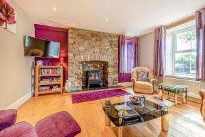 a living room with a stone fireplace at 2 Bed in Llandysul oc-was280 in Rhyd Lewis
