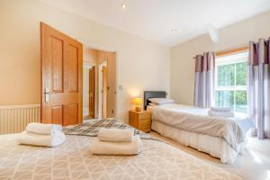 a bedroom with two beds and a window at 2 Bed in Llandysul oc-was280 in Rhyd Lewis