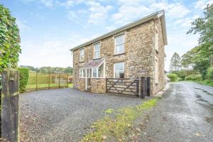 an exterior view of a brick house with a gate at 2 Bed in Llandysul oc-was280 in Rhyd Lewis