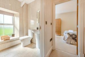 a bathroom with a sink and a toilet and a bed at 2 Bed in Llandysul oc-was280 in Rhyd Lewis +28 photos