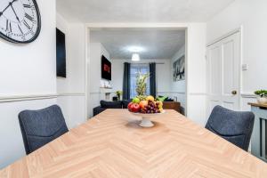 a dining room table with a bowl of fruit on it at 2 Bedroom 5 Single Beds WiFi in Northampton