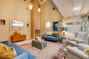 a living room with blue furniture and a brick wall at 3 Bed in Holme-on-Spalding-Moor oc-vy213 in Holme upon Spalding Moor