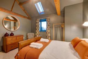 a bedroom with a large bed and a mirror at 3 Bed in Holme-on-Spalding-Moor oc-vy213 in Holme upon Spalding Moor