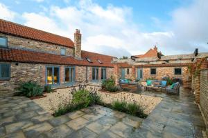 an exterior view of a brick house with a patio at 3 Bed in Holme-on-Spalding-Moor oc-vy213 in Holme upon Spalding Moor