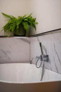 a bathroom sink with a faucet and a plant at 3 Bed in Holme-on-Spalding-Moor oc-vy213 in Holme upon Spalding Moor +24 photos