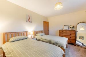 a bedroom with two beds and a dresser at 2 Bed in Renwick oc-h34195 in Renwick