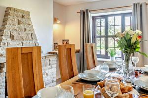 a dining room with a table and a fireplace at 3 Bed in Stackpole oc-c27398 in Stackpole Elidor