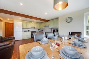 a dining room with a table with plates and glasses at 3 Bed in Llanllechid oc-wag712 in Llanllechid