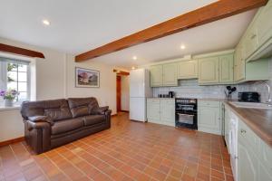 a living room with a couch in a kitchen at 3 Bed in Llanllechid oc-wag712 in Llanllechid +9 photos
