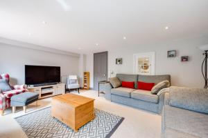 a living room with two couches and a flat screen tv at 4 Bed in Halesworth oc-5river in Halesworth