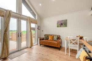 a living room with a couch and a table at 2 Bed in Mouswald oc-b33444 in Mouswald