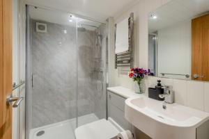 a bathroom with a shower and a sink and a toilet at 2 Bed in Mouswald oc-b33444 in Mouswald +16 photos