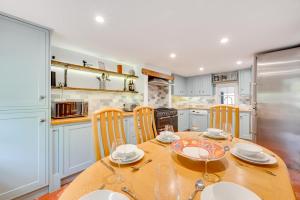 a kitchen with a wooden table with chairs and a dining room at 4 Bed in Halesworth oc-5river in Halesworth