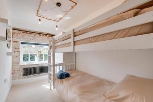 a bedroom with a bunk bed and a window at 4 Bed in Halesworth oc-5river in Halesworth
