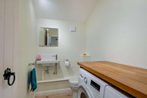 a bathroom with a white toilet and a sink at 2 Bed in Wickhambrook oc-b30507 in Wickhambrook +8 photos
