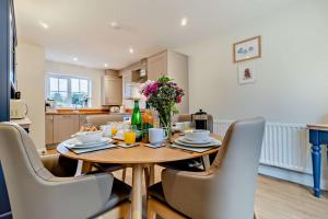 a kitchen and dining room with a wooden table and chairs at 3 Bed in Framlingham oc-f30353 in Framlingham