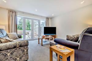 a living room with a couch and a tv at 3 Bed in Framlingham oc-f30353 in Framlingham
