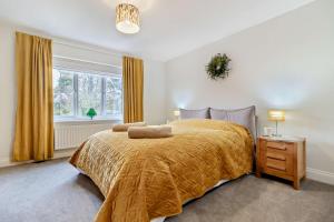 a bedroom with a large bed and a window at 3 Bed in Framlingham oc-f30353 in Framlingham
