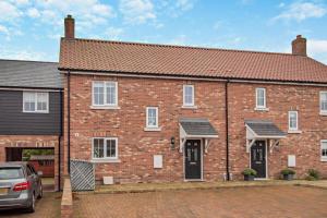 a brick house with a car parked in front of it at 3 Bed in Framlingham oc-f30353 in Framlingham