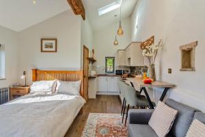 a bedroom with a bed and a table and a kitchen at 1 Bed in Bracewell oc-l33325 in Bracewell