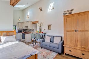 a bedroom with a bed and a chair and a kitchen at 1 Bed in Bracewell oc-l33325 in Bracewell +10 photos