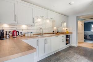 a kitchen with white cabinets and a sink at 1 Bed in Wymondham oc-e32664 in Wymondham