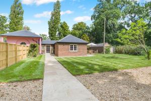 a brick house with a fence and a yard at 1 Bed in Wymondham oc-e32664 in Wymondham