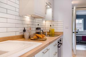 a kitchen with white walls and a counter top with food at 1 Bed in Wymondham oc-e32664 in Wymondham +9 photos