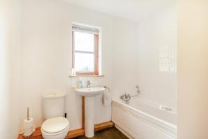 a white bathroom with a toilet and a sink at 3 Bed in Shebbear oc-l32583 in Shebbear +15 photos