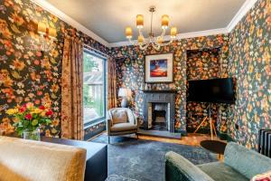 a living room with a fireplace and floral wallpaper at 3 Bed in Thelwall oc-c29954 in Warrington