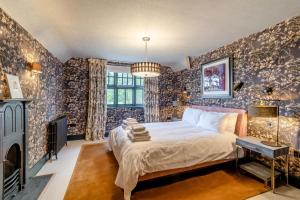 a bedroom with a bed in a room with wallpaper at 3 Bed in Thelwall oc-c29954 in Warrington