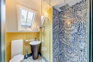 a bathroom with a toilet and a glass shower door at 3 Bed in Thelwall oc-c29954 in Warrington +27 photos