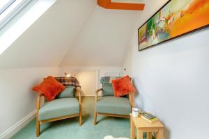 a attic room with two chairs and a tv at 1 Bed in Clatcombe oc-s33309 in Castletown
