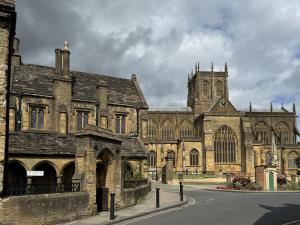 an old stone building with a church with a tower at 1 Bed in Clatcombe oc-s33309 in Castletown