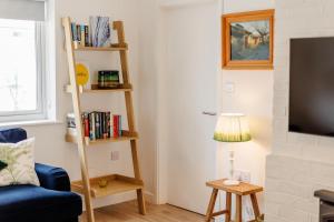 a living room with a blue couch and a tv at 3 Bed in Camber oc-s27568 in Camber