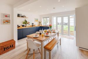 a dining room with a table and chairs and a kitchen at 3 Bed in Camber oc-s27568 in Camber