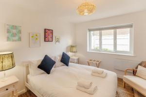 a bedroom with a large white bed and a couch at 3 Bed in Camber oc-s27568 in Camber