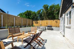 a patio with chairs and a table and a fence at 3 Bed in Camber oc-s27568 in Camber