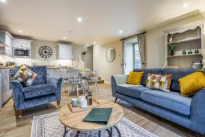 a living room with a blue couch and a table at 2 Bed in Castleton oc-p34012 in Castleton