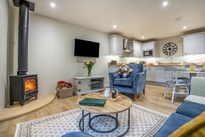 a living room with a couch and a table and a fireplace at 2 Bed in Castleton oc-p34012 in Castleton