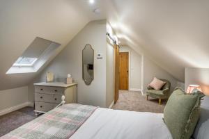 a attic bedroom with a bed and a chair at 2 Bed in Castleton oc-p34012 in Castleton