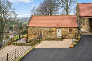 a small brick building with a red roof at 2 Bed in Castleton oc-p34012 in Castleton