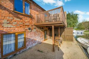 a brick building with a staircase and a deck at 2 Bed in Smallburgh oc-m33732 in Dilham